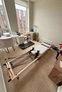 A Studio Reformer set up in a small apartment room