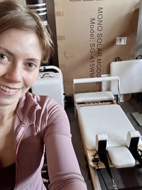 Rachel beside her Studio Reformer at home