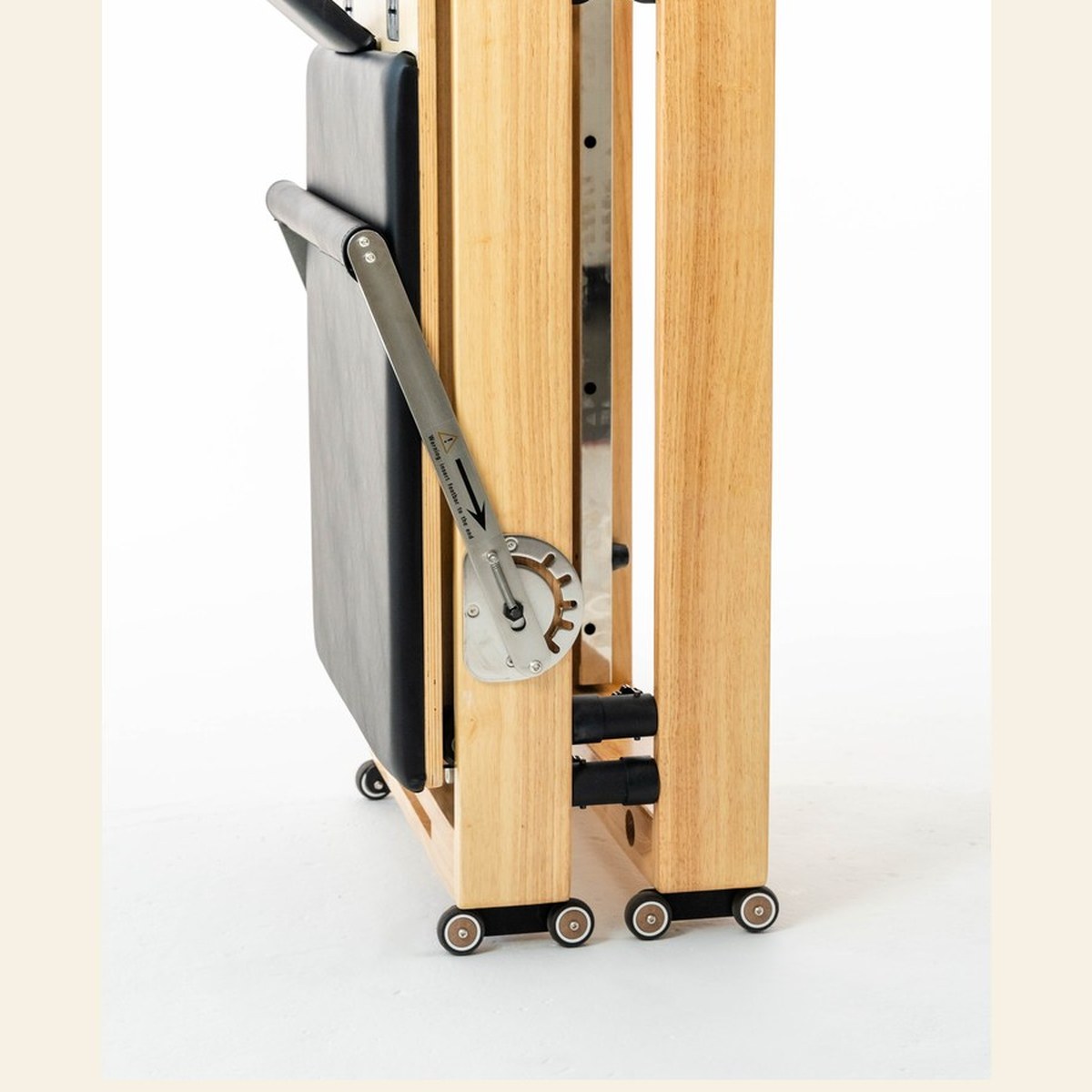 The Seren reformer folded into a slim upright tower on wheels