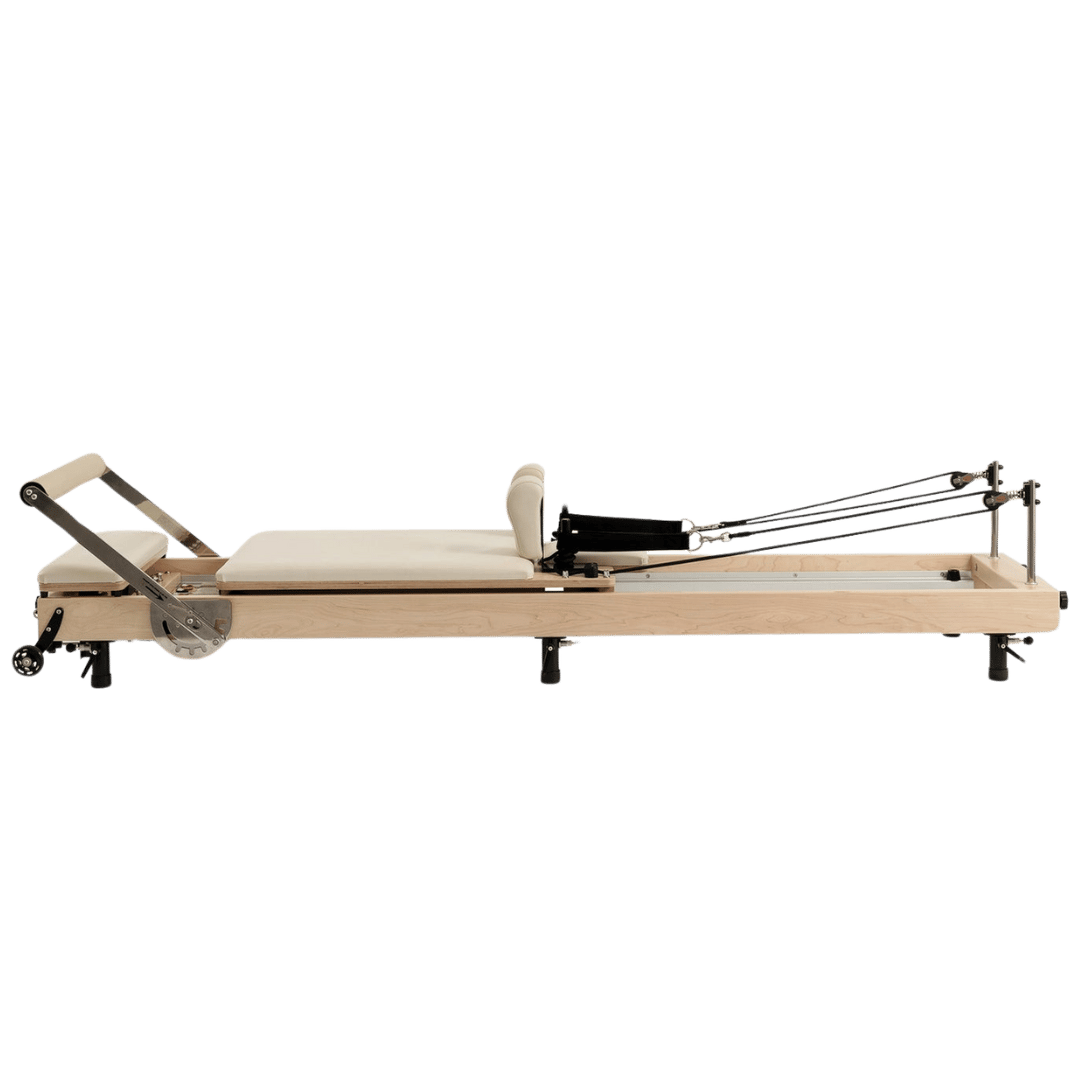Wooden Pilates reformer with padded seat and adjustable straps.